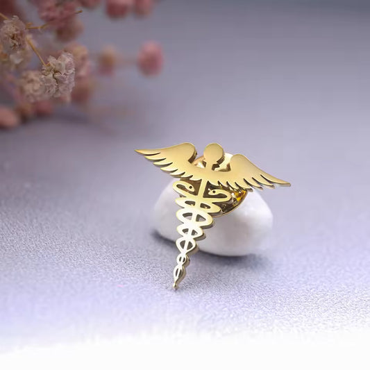 Broche caducée doré