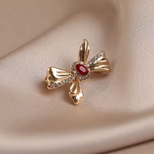 Broche nœud pierre rouge photo