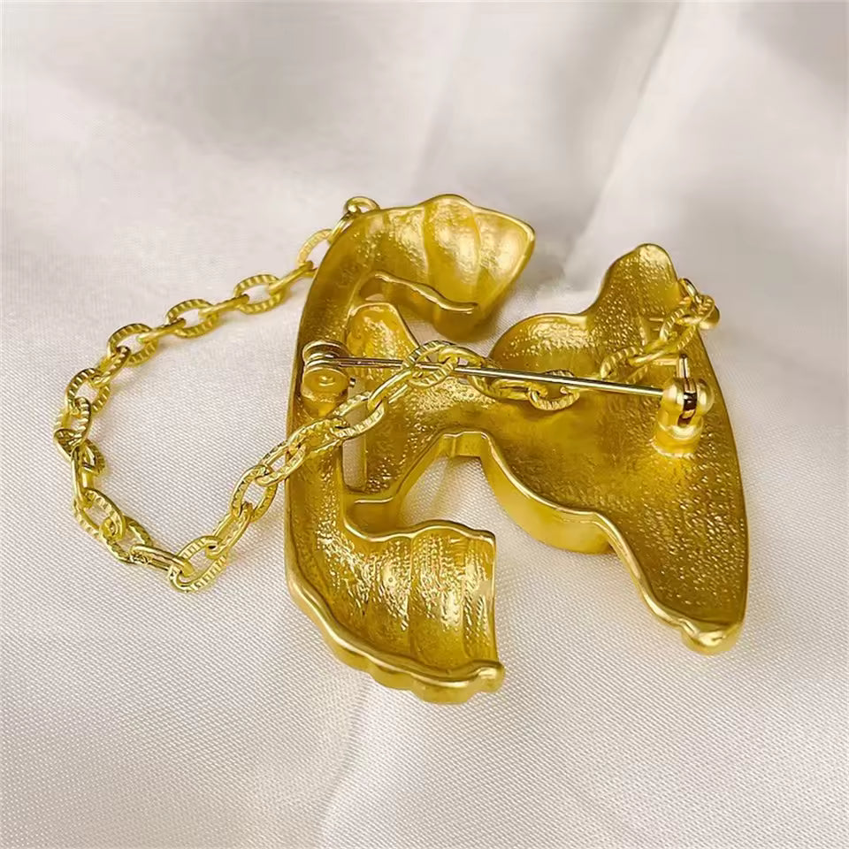 Broche appel doré vue de dos, fermoir épingle