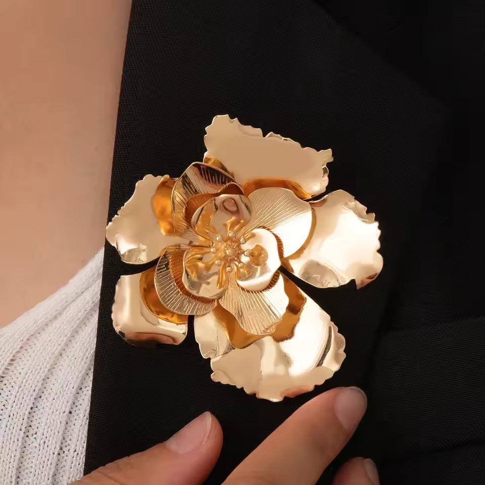 Broche fleur éclat d'or portée sur une tenue